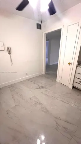 a view of a room with a cabinet and floor to ceiling window