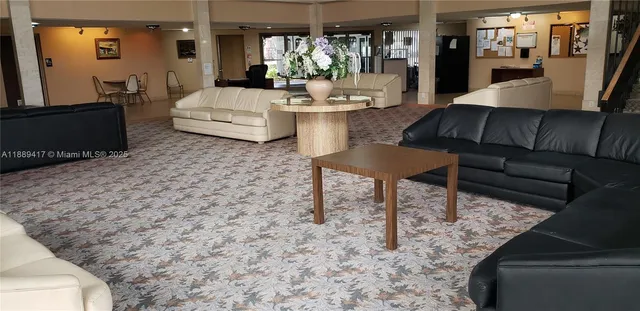 a sitting area with chairs and table