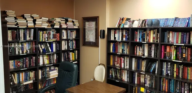 a view of a yard with a table and chairs under an umbrella