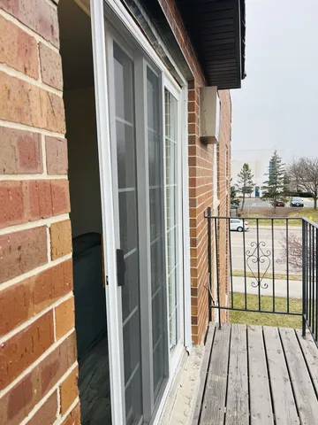a view of a balcony with wooden floor and fence
