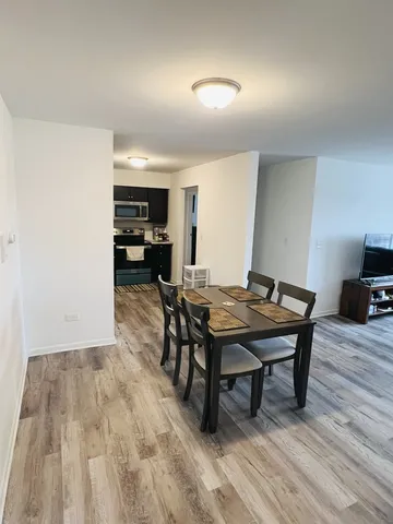 a view of a workspace with furniture and wooden floor