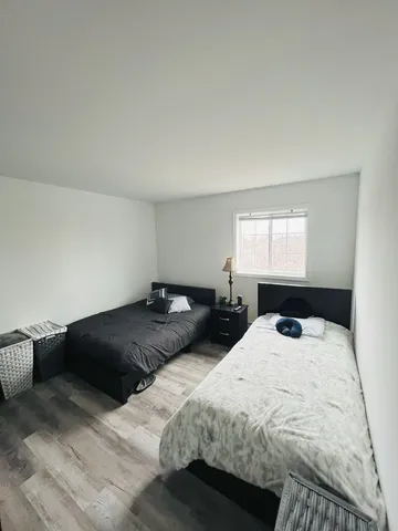 a bedroom with a bed and window