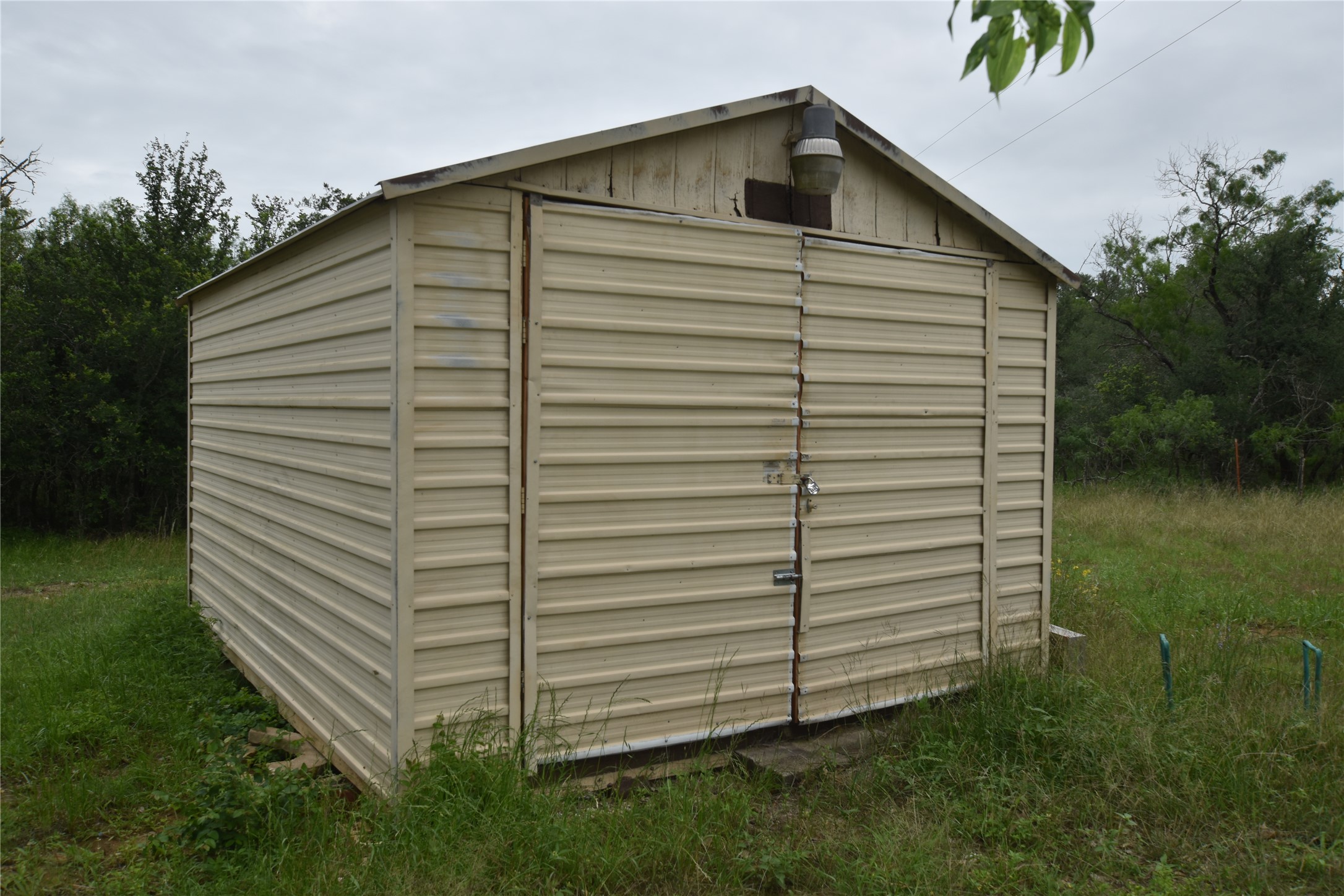 687 Fm 812 Road Red Rock, TX 78662 - Photo 40 of 40 Corrugated metal shed with double entry doors and an exterior light fixture