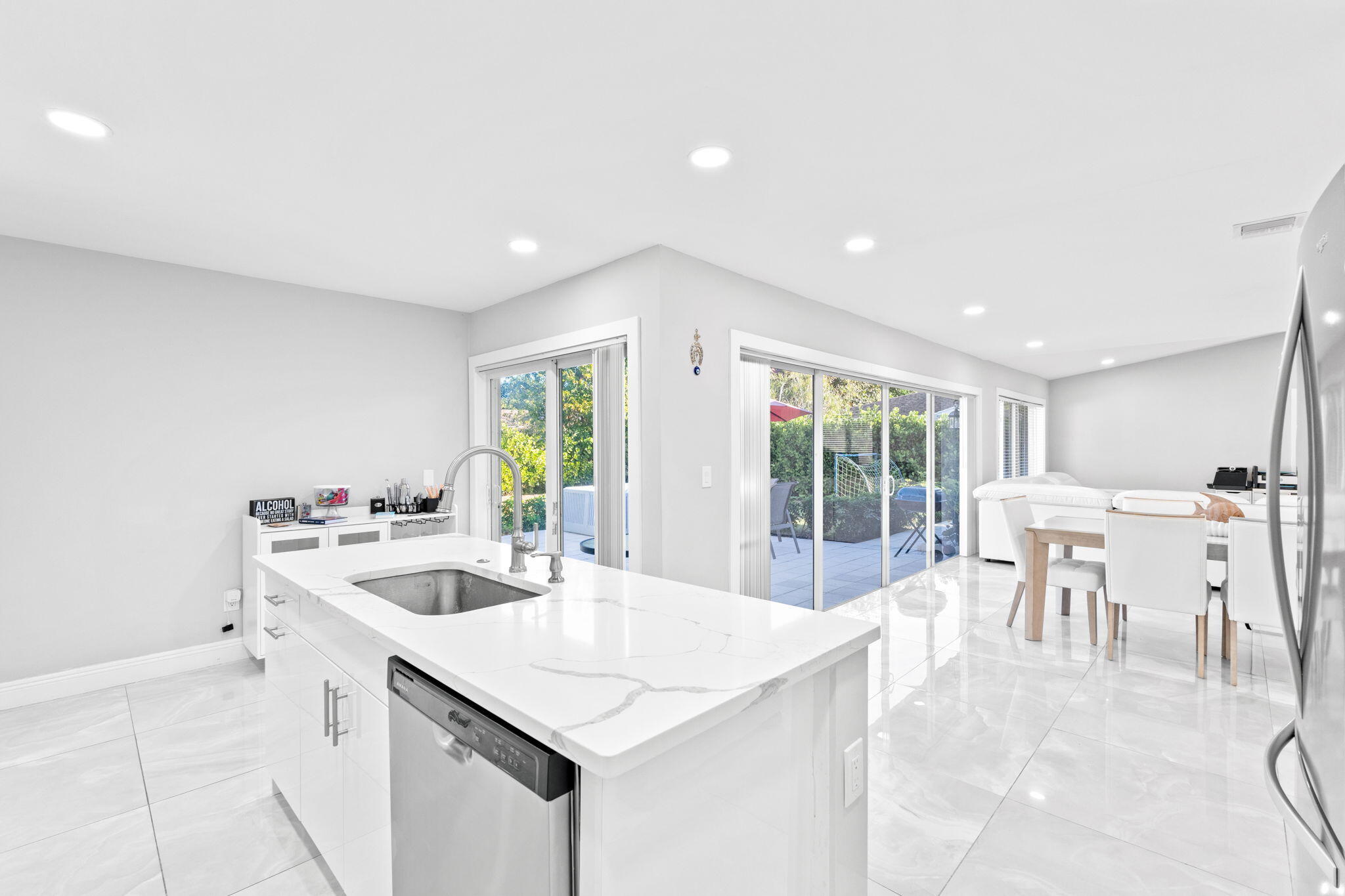 12293 Old Country Road South Wellington, FL 33414 - Photo 11 of 32 a kitchen with a table chairs stove and cabinets