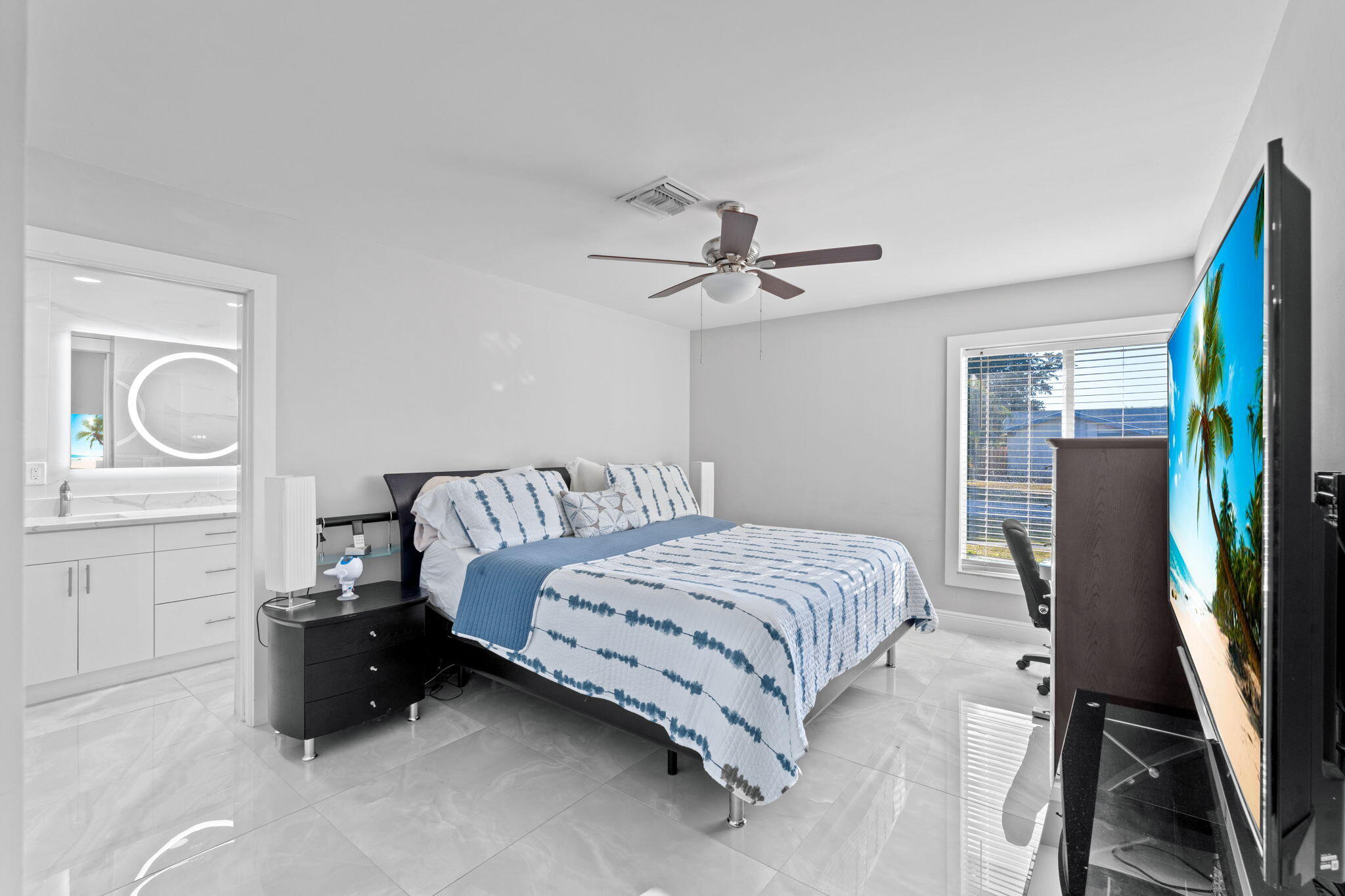 12293 Old Country Road South Wellington, FL 33414 - Photo 13 of 32 a bedroom with a bed a dresser and a large mirror