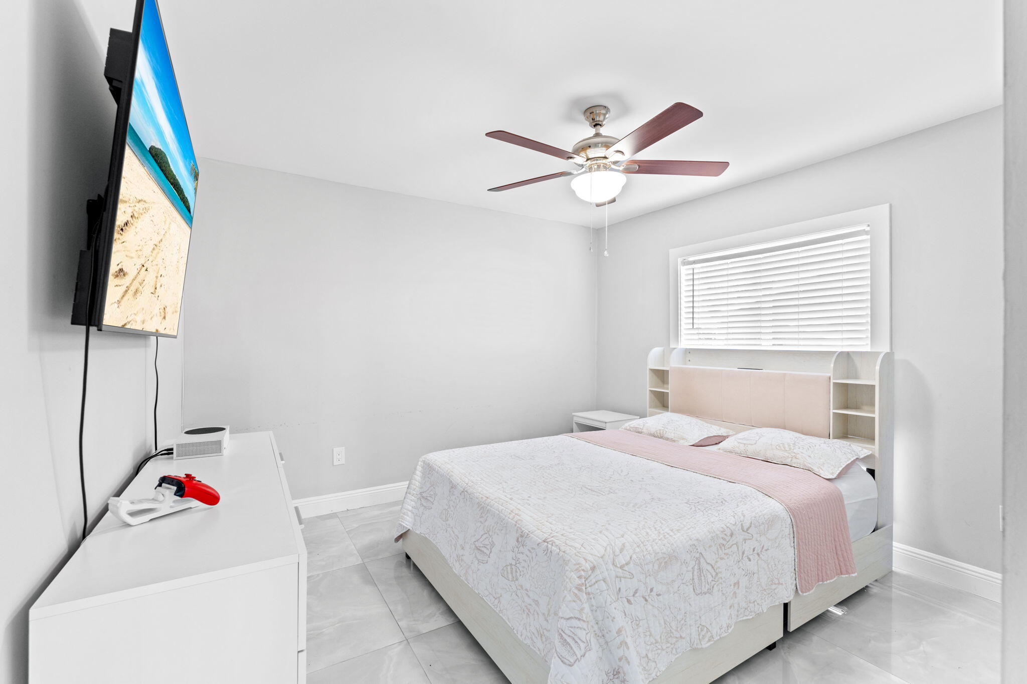 12293 Old Country Road South Wellington, FL 33414 - Photo 17 of 32 a bedroom with a bed and a chandelier