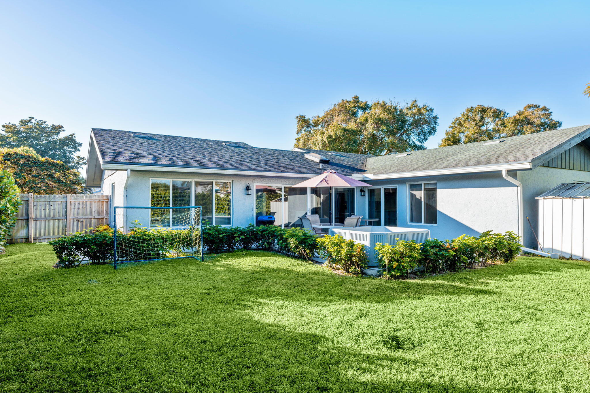 12293 Old Country Road South Wellington, FL 33414 - Photo 25 of 32 a front view of a house with garden