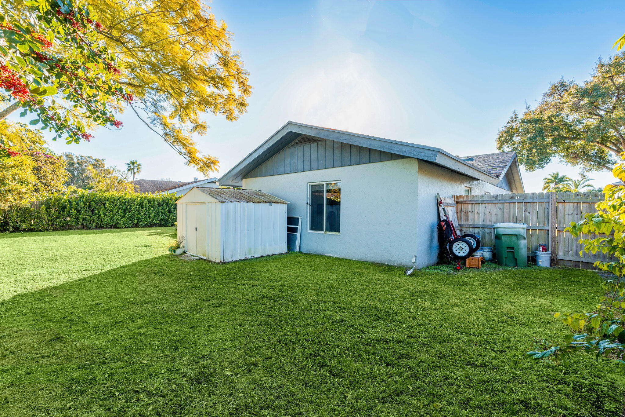 12293 Old Country Road South Wellington, FL 33414 - Photo 28 of 32 a front view of a house with a yard and garage