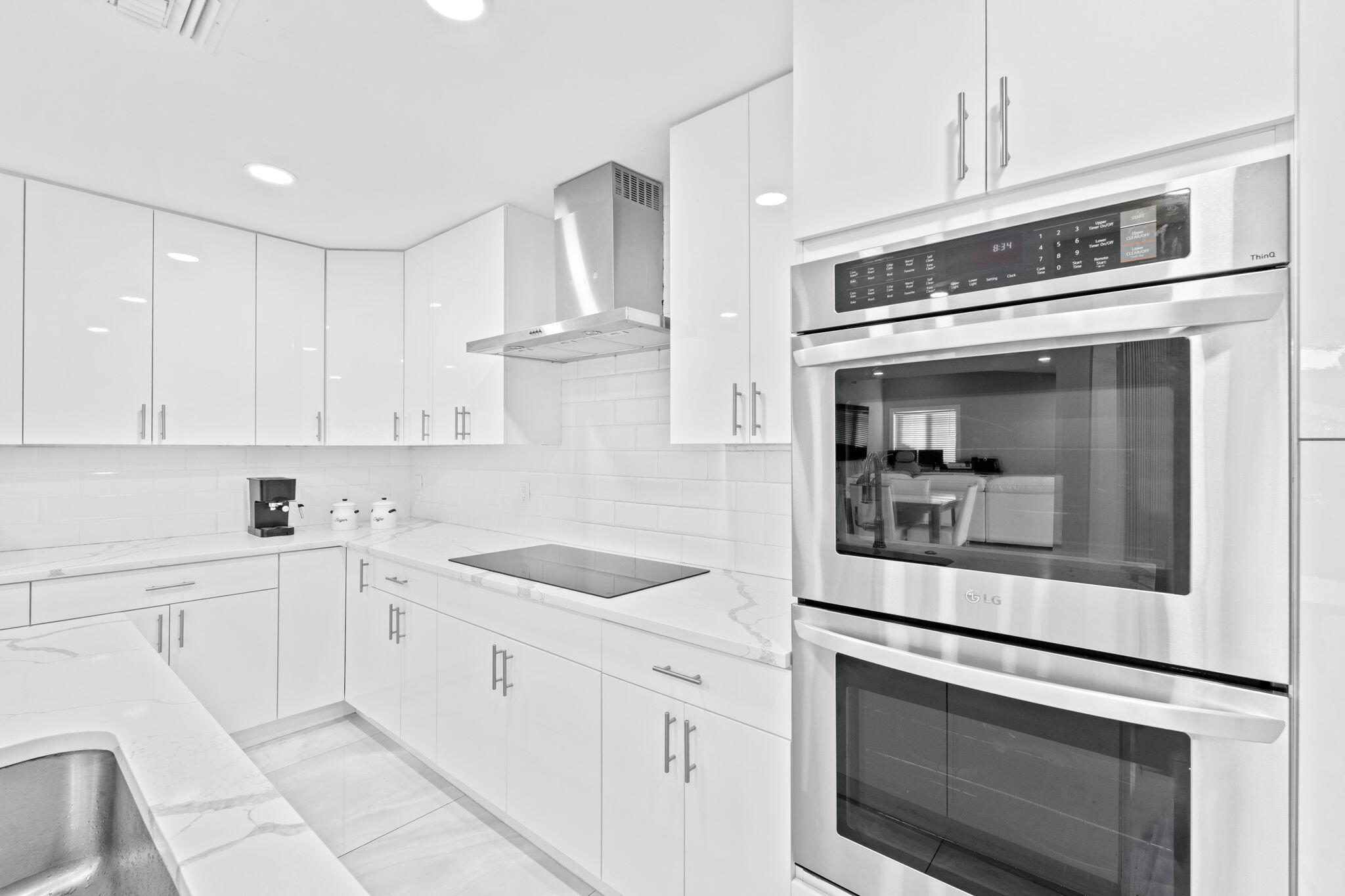 12293 Old Country Road South Wellington, FL 33414 - Photo 9 of 32 a kitchen with white cabinets and sink