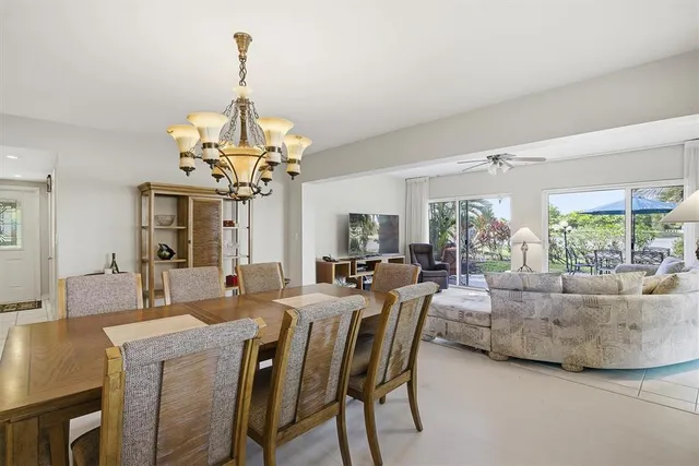 a dining room with furniture a rug and a chandelier