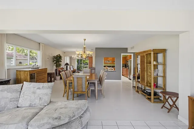 a living room with furniture a rug and a flat screen tv