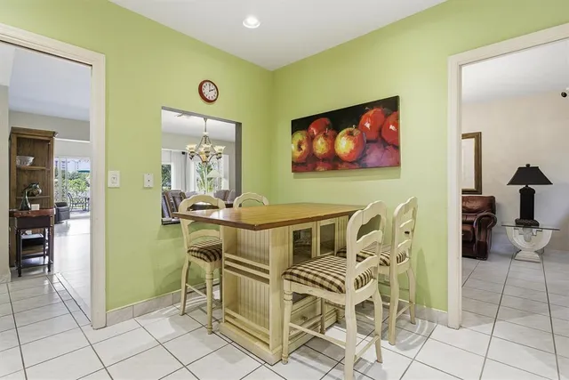 a kitchen with stainless steel appliances a stove a refrigerator a sink a oven with white cabinets and wooden floor