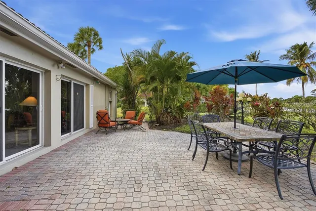 a view of a backyard with furniture and a garden
