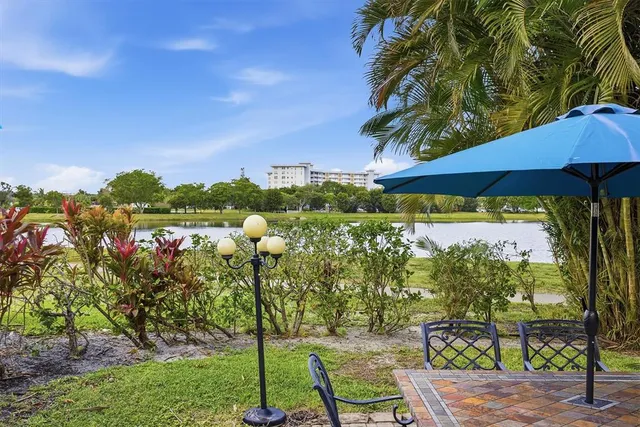 a view of swimming pool with outdoor seating and plants