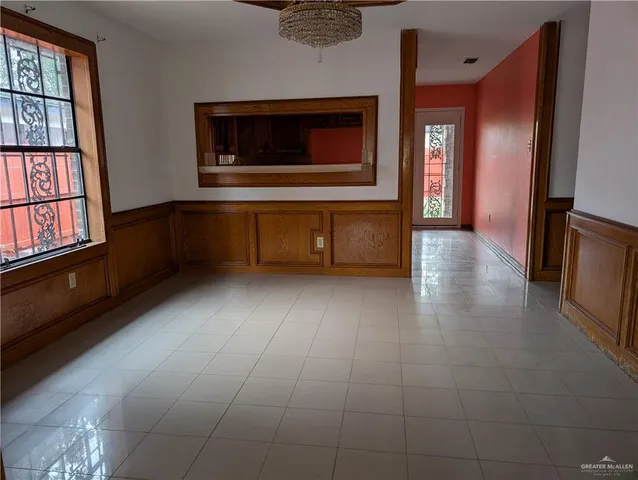 a view of an empty room with a fireplace and a window