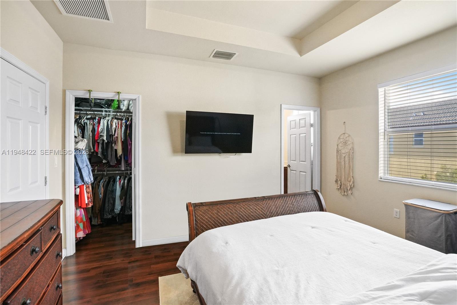 9105 Southwest 227th Street, Unit 9 Cutler Bay, FL 33190 - Photo 12 of 37 a bedroom with a bed and a flat tv screen on the dresser