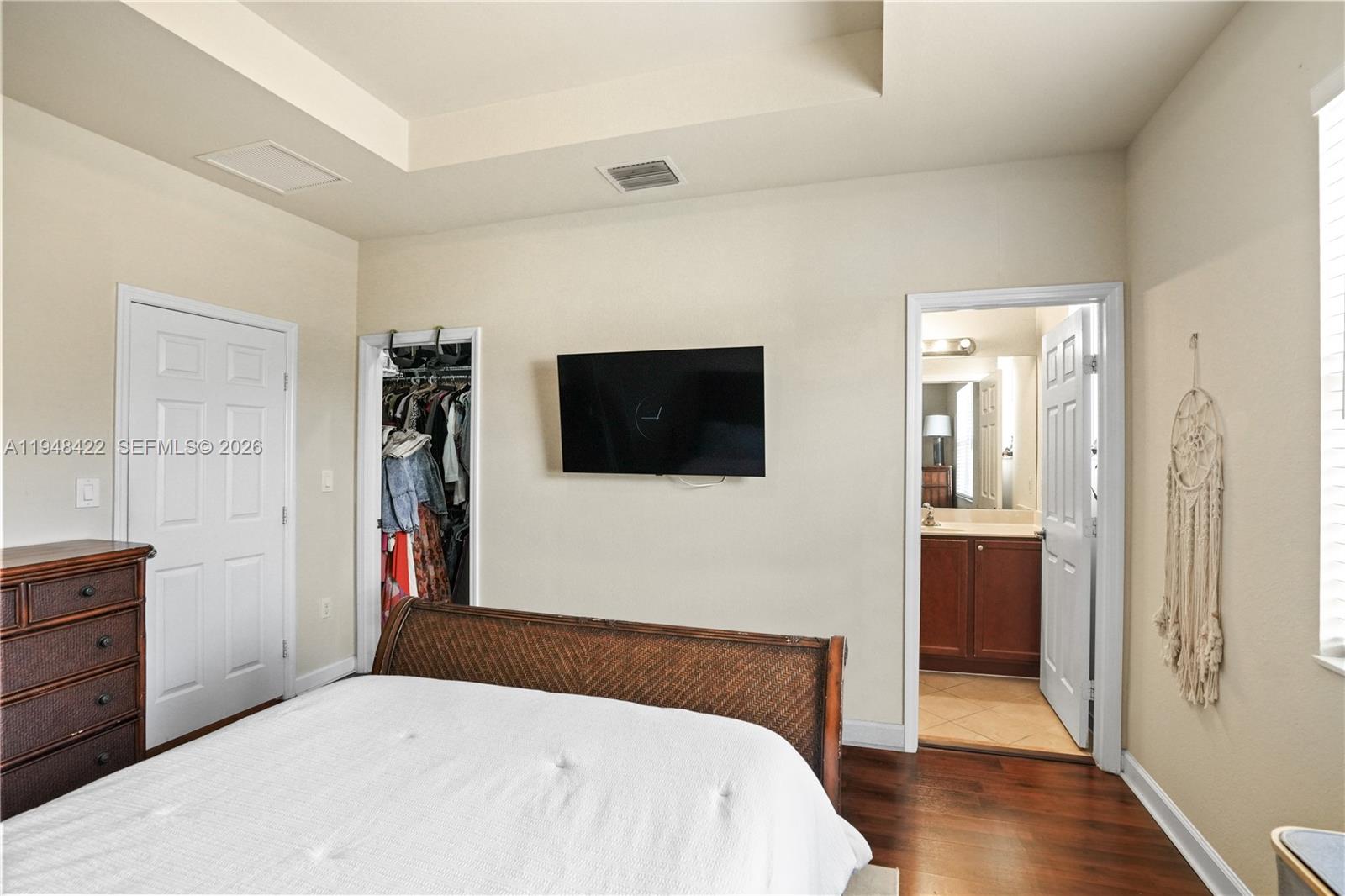 9105 Southwest 227th Street, Unit 9 Cutler Bay, FL 33190 - Photo 13 of 37 a bedroom with a bed and a flat screen tv