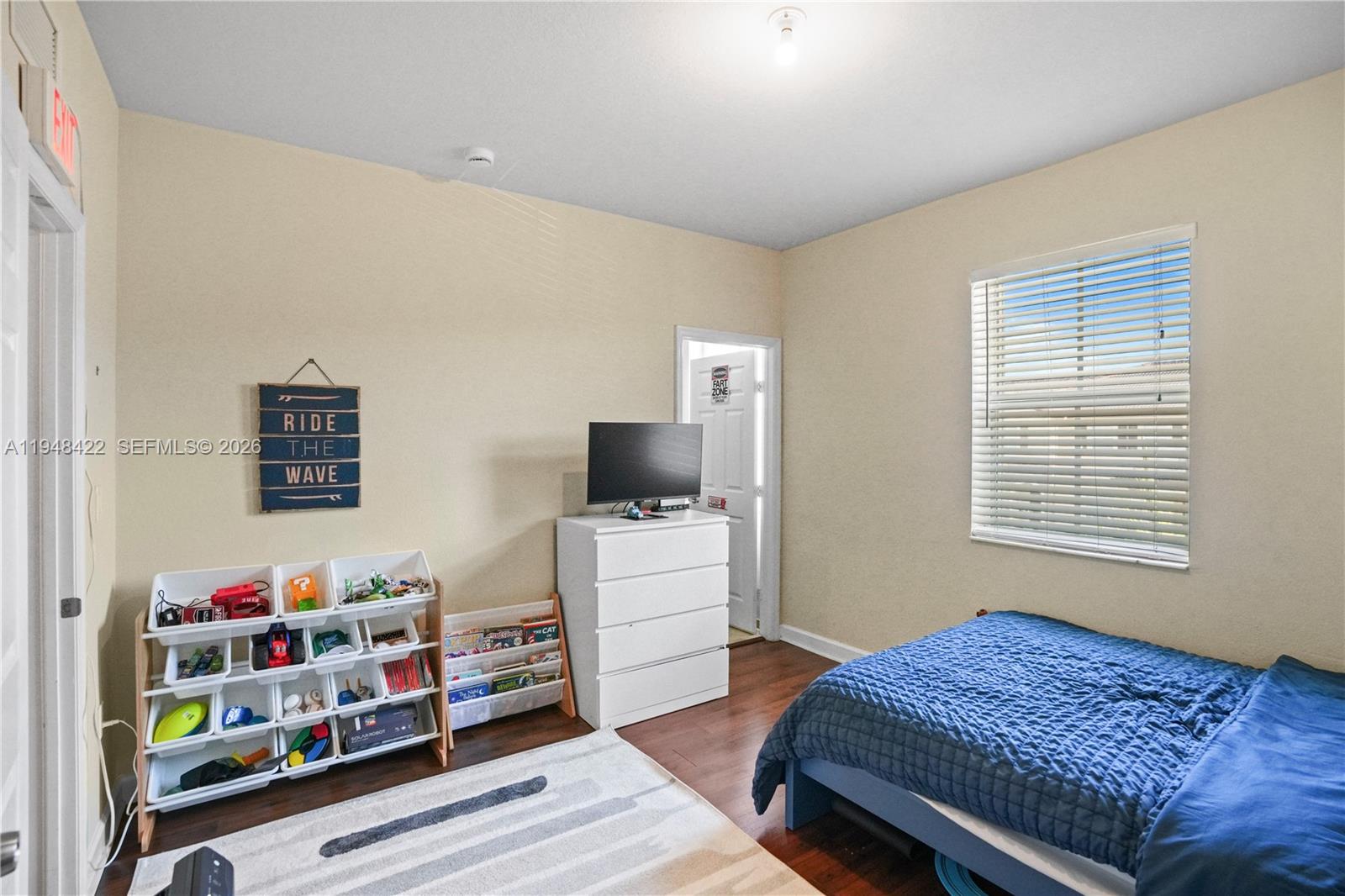 9105 Southwest 227th Street, Unit 9 Cutler Bay, FL 33190 - Photo 19 of 37 a bedroom with furniture and a window