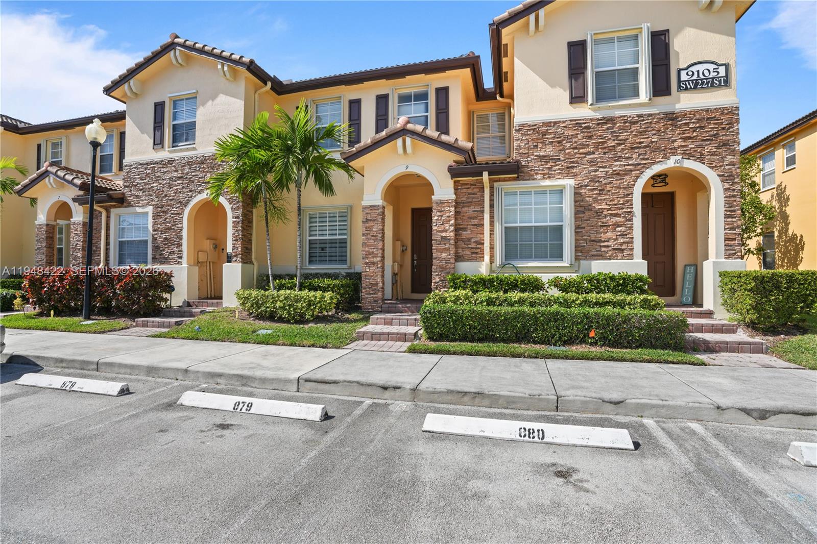 9105 Southwest 227th Street, Unit 9 Cutler Bay, FL 33190 - Photo 26 of 37 front view of house with a yard