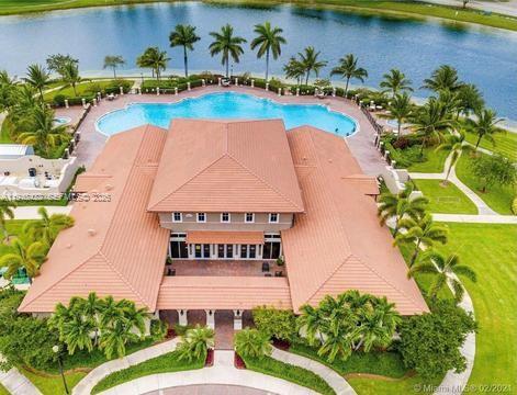 9105 Southwest 227th Street, Unit 9 Cutler Bay, FL 33190 - Photo 36 of 37 an aerial view of a house with a swimming pool yard and lake view