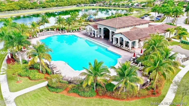 an aerial view of a house with swimming pool garden and patio