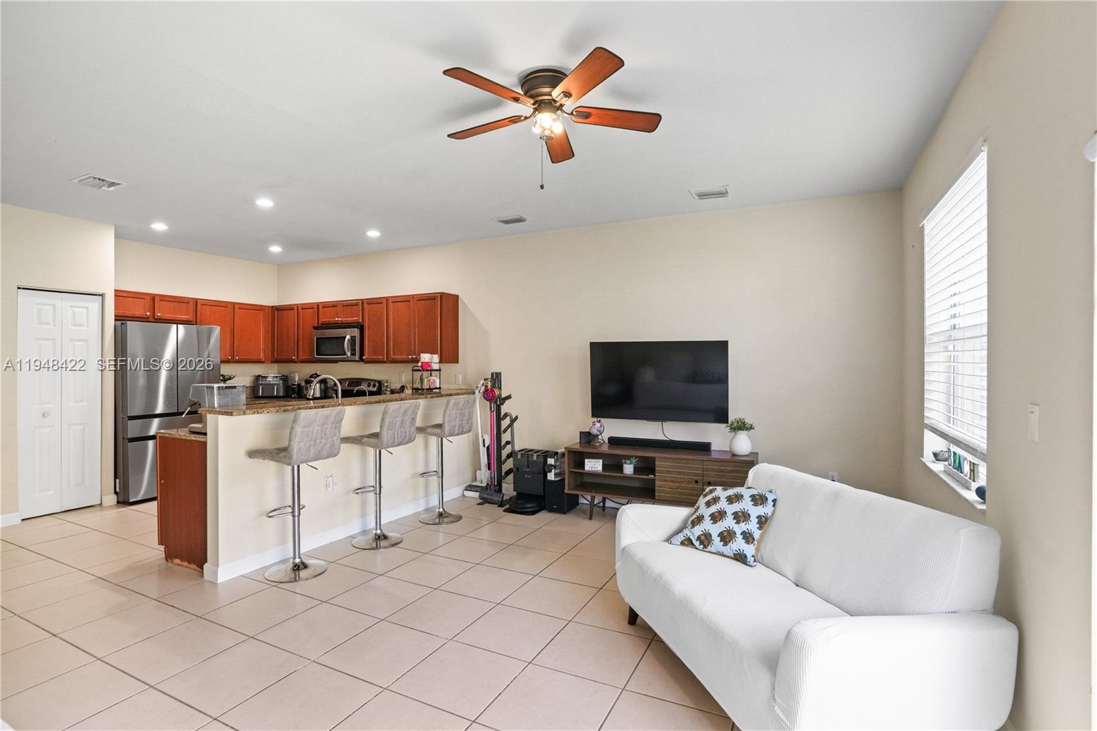 9105 Southwest 227th Street, Unit 9 Cutler Bay, FL 33190 - Photo 7 of 37 a living room with furniture and kitchen view
