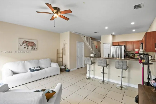 a living room with furniture and kitchen view