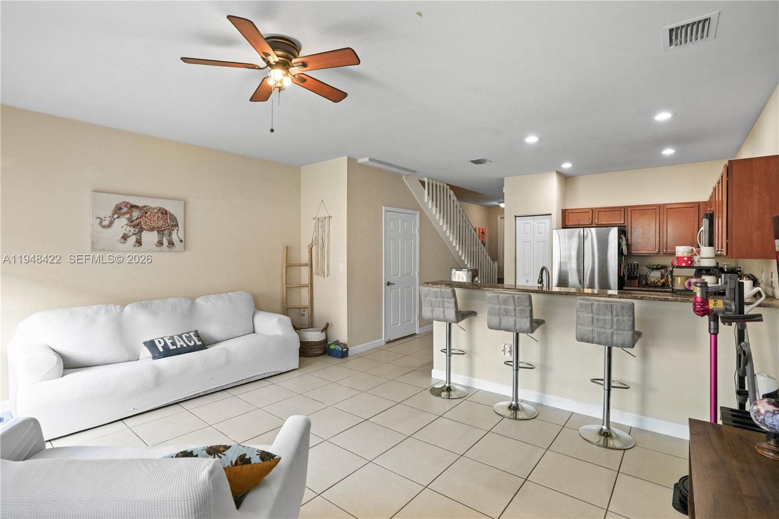 9105 Southwest 227th Street, Unit 9 Cutler Bay, FL 33190 - Photo 8 of 37 a living room with furniture and kitchen view