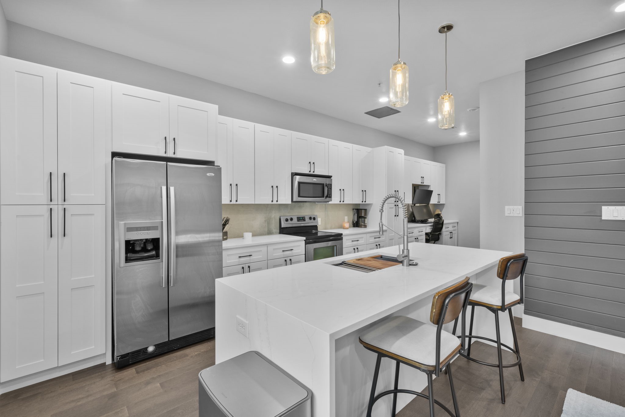 207 Pierce Street, Unit 209 Houston, TX 77002 - Photo 5 of 13 a kitchen with a refrigerator a stove a sink a dining table and chairs