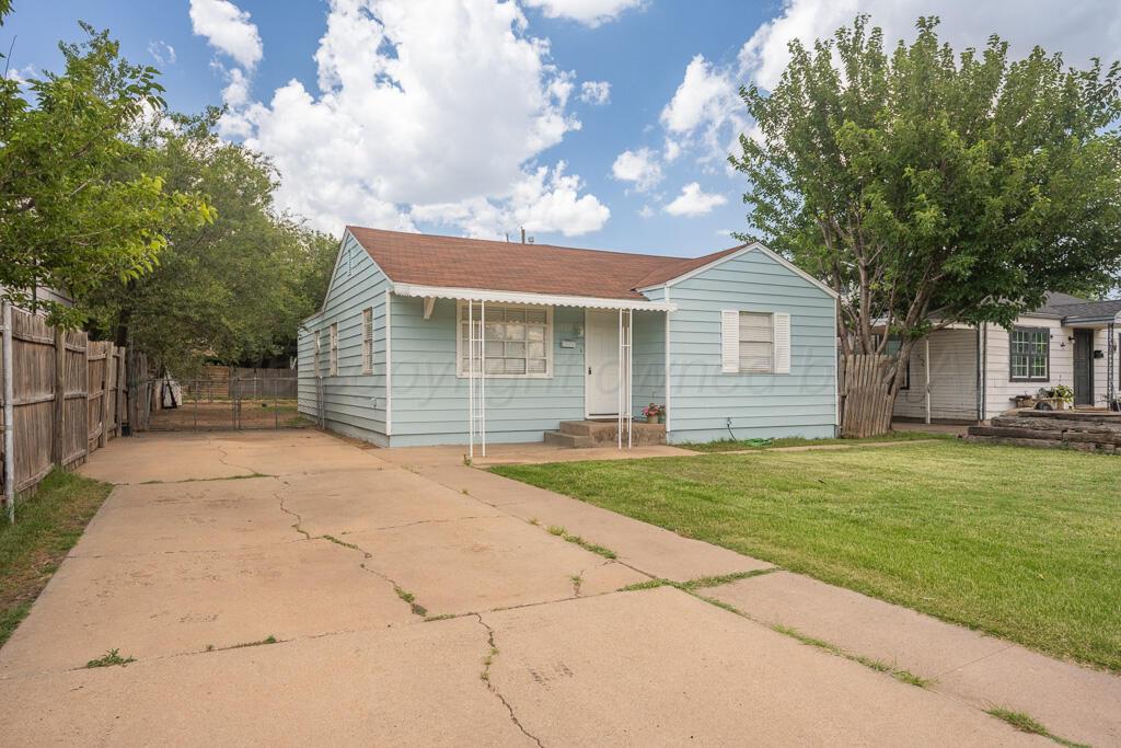 312 Southwest 45th Avenue Amarillo, TX 79110 - Photo 2 of 23 a front view of a house with a garden