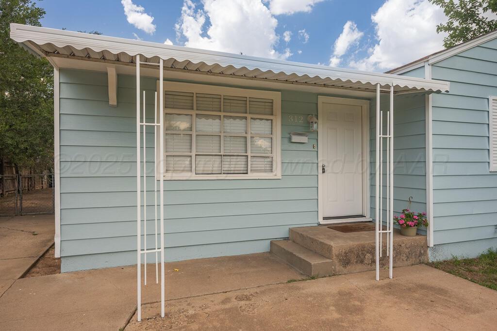 312 Southwest 45th Avenue Amarillo, TX 79110 - Photo 4 of 23 a view of a house with a door and a window