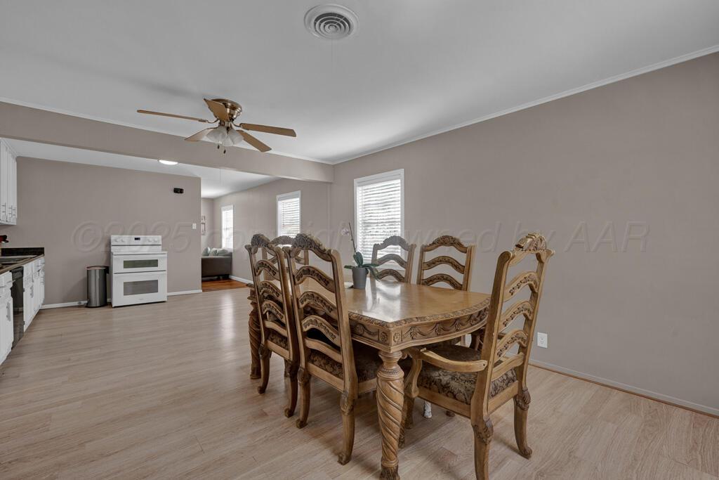 312 Southwest 45th Avenue Amarillo, TX 79110 - Photo 9 of 23 a view of a a dining room with furniture and wooden floor