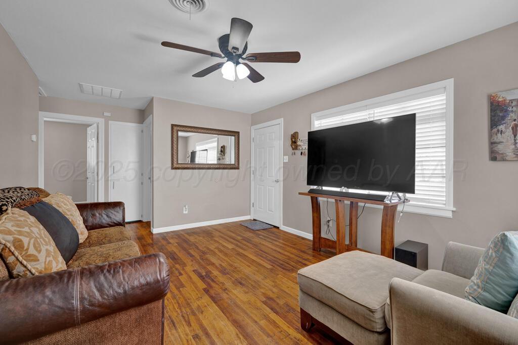 312 Southwest 45th Avenue Amarillo, TX 79110 - Photo 10 of 23 a living room with furniture and a flat screen tv