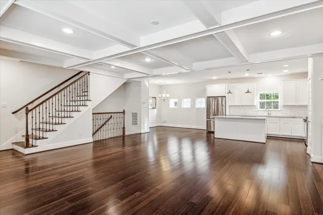 a kitchen with a refrigerator and white cabinets