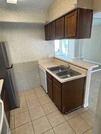a kitchen with a cabinets and a stove top oven