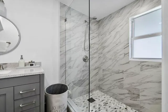 a bathroom with a granite countertop toilet sink and shower