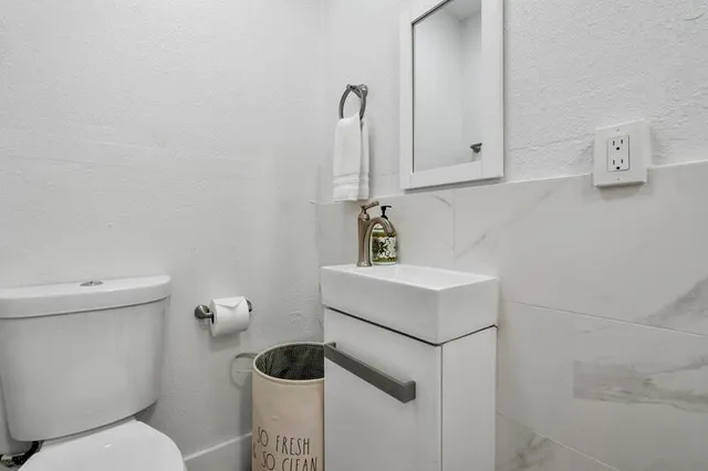 a bathroom with a sink toilet and vanity