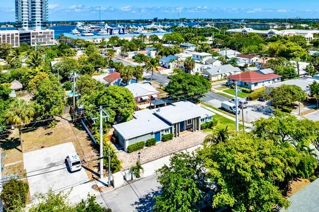 an aerial view of residential houses with outdoor space and street view