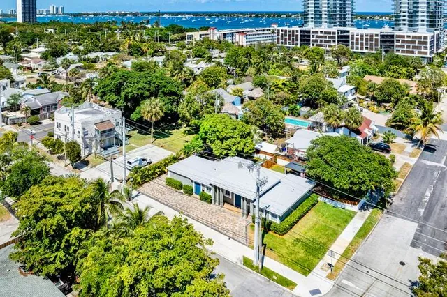 an aerial view of a house with a yard basket ball court and outdoor seating