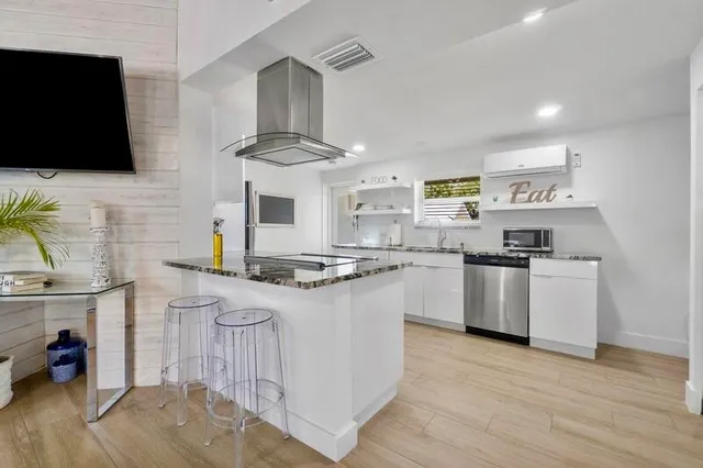a kitchen with stainless steel appliances granite countertop a stove and a sink