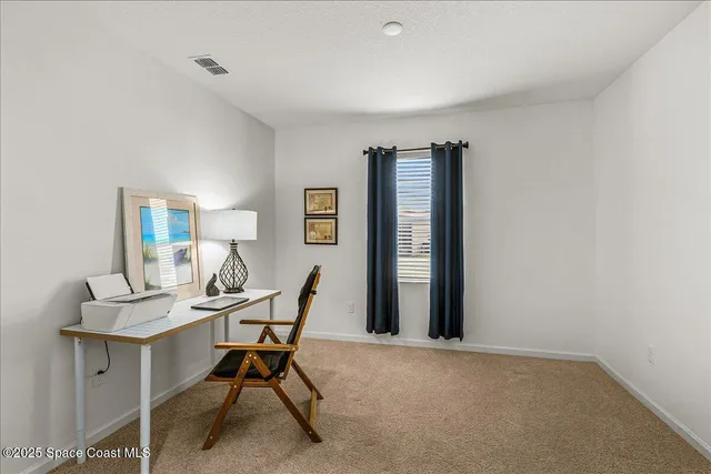 a view of a livingroom with furniture and a window