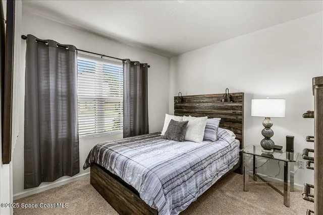 a bedroom with a large bed and a window