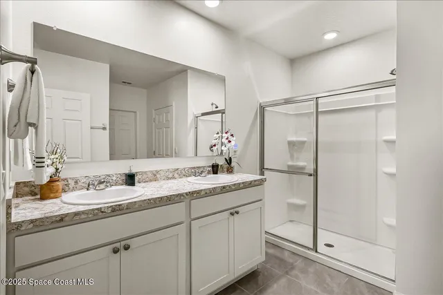 a bathroom with a double vanity sink and mirror