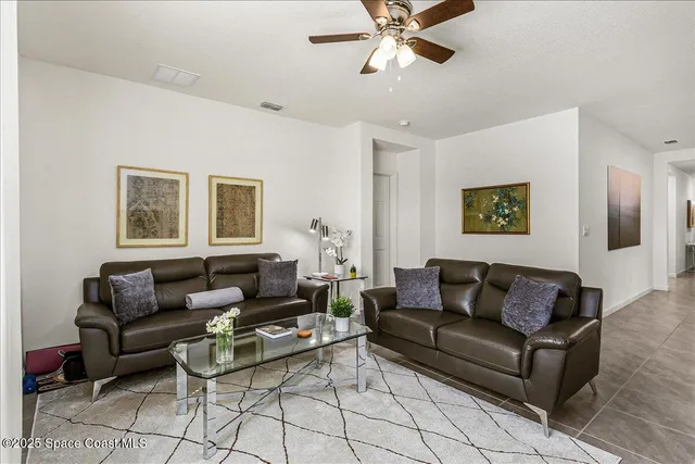 a living room with furniture and a view of wooden floor