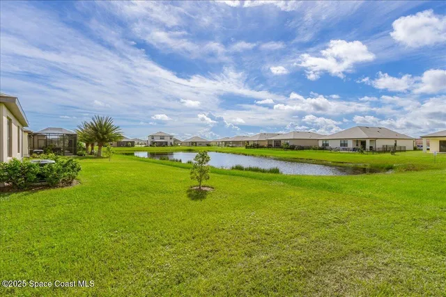 an aerial view of a house with a swimming pool outdoor seating and yard