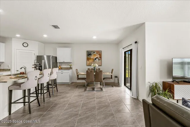 a living room with furniture a table and chairs
