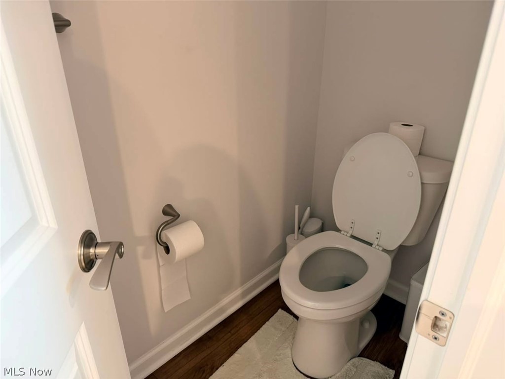 863 River Run Road Aurora, OH 44202 - Photo 30 of 47 Compact powder room featuring a white toilet, wood-finish flooring, and white baseboards