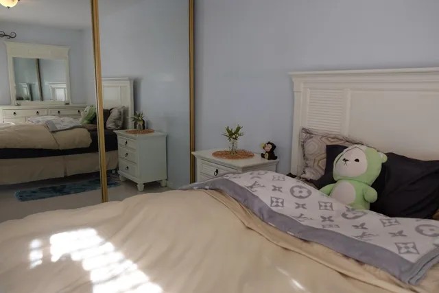 a bedroom with a bed and a dresser