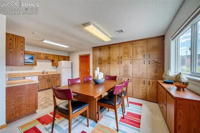 a kitchen with stainless steel appliances granite countertop a refrigerator a stove top oven a sink and dishwasher