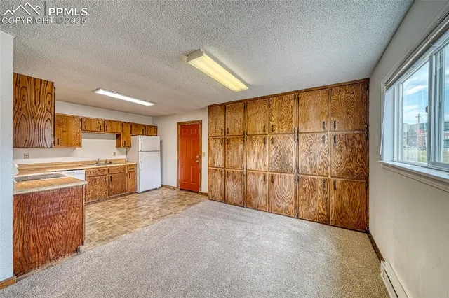 a kitchen with a refrigerator and a sink
